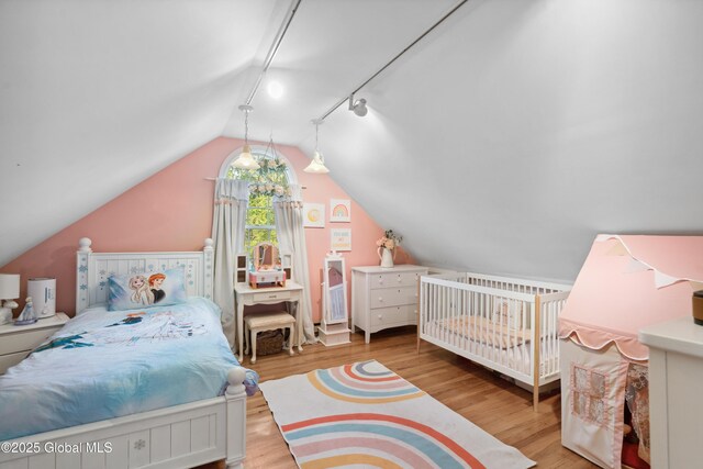 2400 Curry Rd, Schenectady, NY 12303 - bedroom with vaulted ceiling, rail lighting, and wood finished floors
