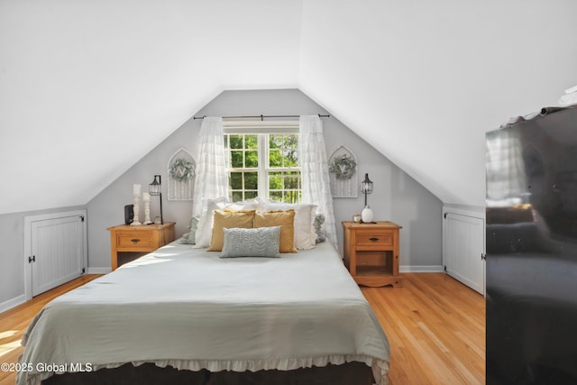 2400 Curry Rd, Schenectady, NY 12303 - bedroom with wood finished floors, vaulted ceiling, and baseboards