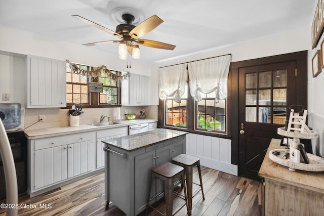 2400 Curry Rd, Schenectady, NY 12303 - kitchen with a sink, dishwashing machine, light countertops, ceiling fan, and crown molding