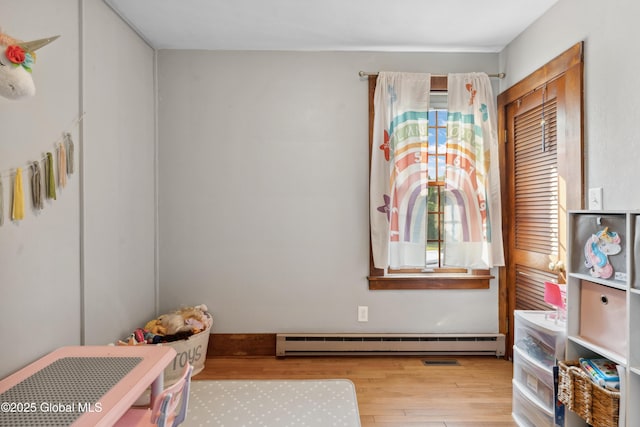 2400 Curry Rd, Schenectady, NY 12303 - playroom with baseboard heating and wood finished floors