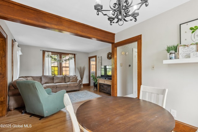 2400 Curry Rd, Schenectady, NY 12303 - dining space with a chandelier, light wood-style floors, and baseboards