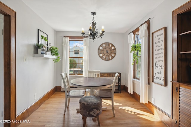 2400 Curry Rd, Schenectady, NY 12303 - dining room featuring healthy amount of natural light, a chandelier, light wood-style flooring, and baseboards