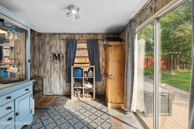 2400 Curry Rd, Schenectady, NY 12303 - doorway to outside with wooden walls and stone tile floors