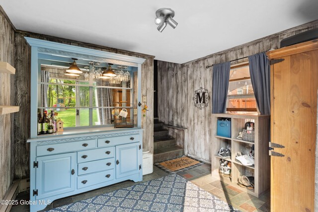 2400 Curry Rd, Schenectady, NY 12303 - doorway to outside with stairs, a baseboard heating unit, and wooden walls