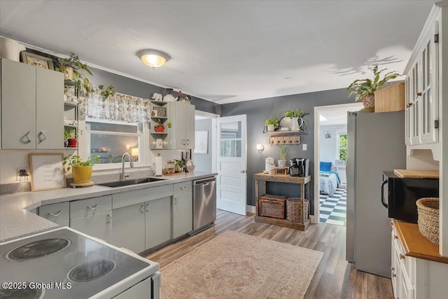 3287 Ny Highway 43, Sand Lake, NY 12018 - kitchen with a sink, open shelves, appliances with stainless steel finishes, and wood finished floors