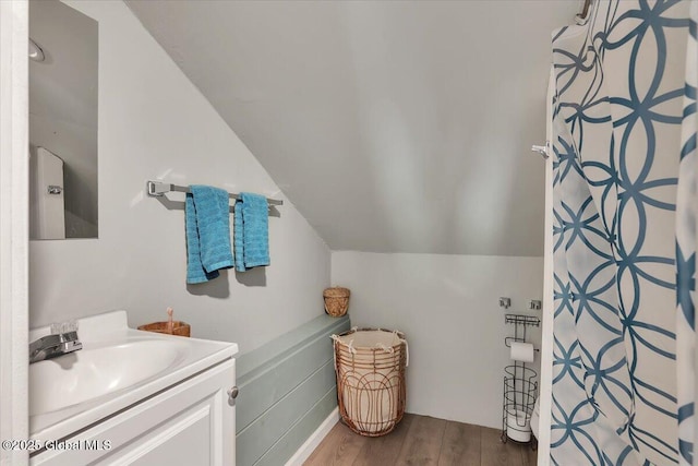 3287 Ny Highway 43, Sand Lake, NY 12018 - full bathroom with wood finished floors, vanity, vaulted ceiling, and a shower with shower curtain