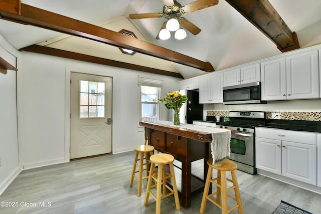 235 Maple Ave, Saratoga Springs, Inside, NY 12866 - kitchen featuring stainless steel appliances, white cabinetry, light wood finished floors, and dark countertops