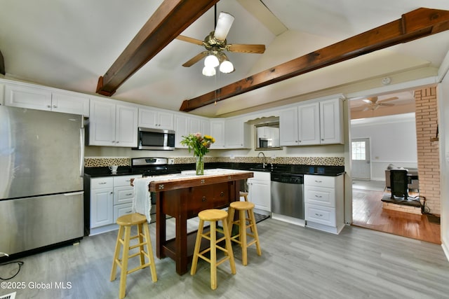 235 Maple Ave, Saratoga Springs, Inside, NY 12866 - kitchen featuring appliances with stainless steel finishes, ceiling fan, light wood finished floors, and white cabinetry