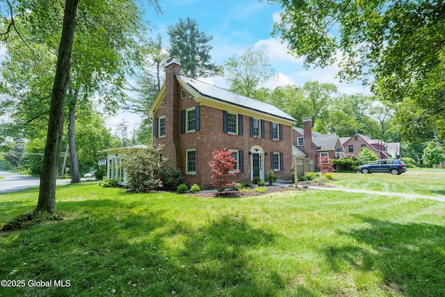 2 Darroch Rd, Bethlehem, NY 12054 - colonial house with a chimney, a front yard, and brick siding