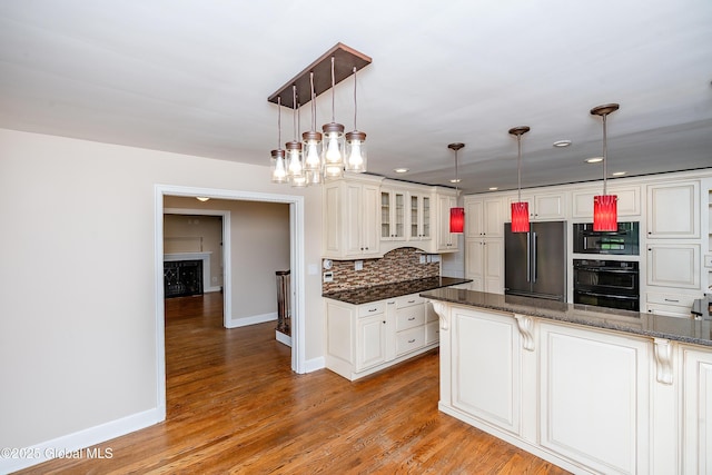 2 Darroch Rd, Bethlehem, NY 12054 - kitchen with freestanding refrigerator, baseboards, backsplash, glass insert cabinets, and recessed lighting