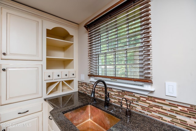 2 Darroch Rd, Bethlehem, NY 12054 - kitchen view of a sink, tasteful backsplash, dark stone countertops, and cream cabinets