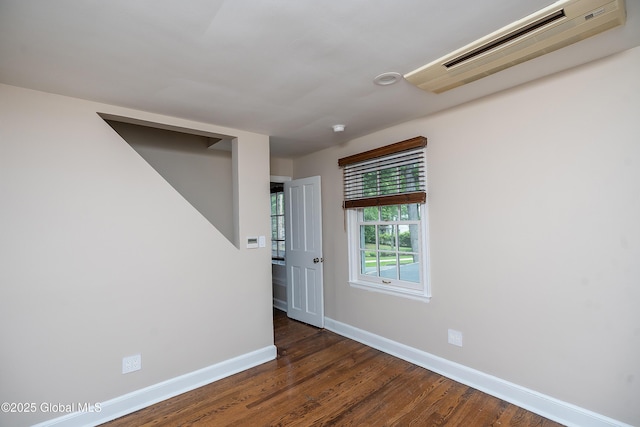 2 Darroch Rd, Bethlehem, NY 12054 - unfurnished room with a wall mounted AC, baseboards, and dark wood-style floors