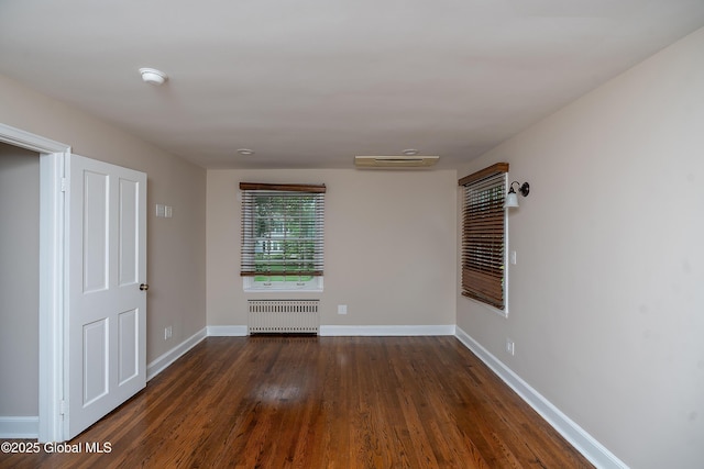 2 Darroch Rd, Bethlehem, NY 12054 - spare room featuring radiator, dark wood-type flooring, baseboards, a smoke detector, and a wall mounted AC