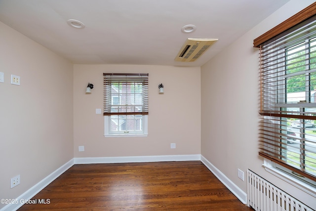 2 Darroch Rd, Bethlehem, NY 12054 - unfurnished room with plenty of natural light, dark wood-style floors, baseboards, and radiator