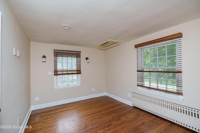 2 Darroch Rd, Bethlehem, NY 12054 - spare room featuring radiator heating unit, dark wood finished floors, and baseboards