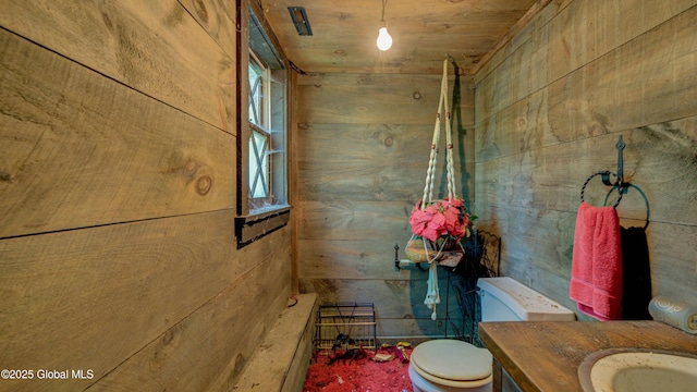 824 County Highway 106, Mayfield, NY 12010 - bathroom featuring wood walls, toilet, and vanity