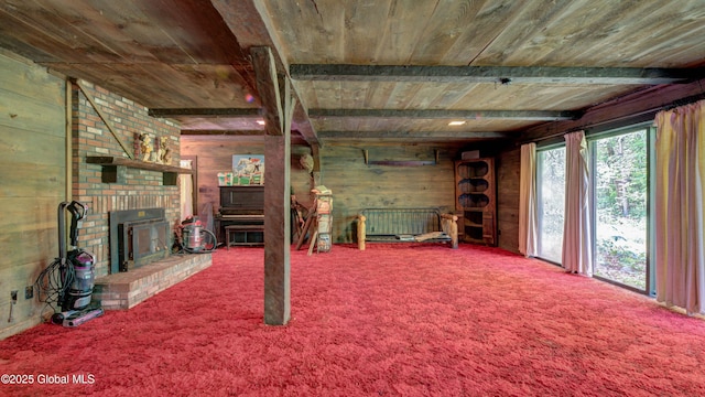 824 County Highway 106, Mayfield, NY 12010 - unfurnished living room featuring wooden ceiling with exposed beams, wooden walls, a brick fireplace, and carpet floors
