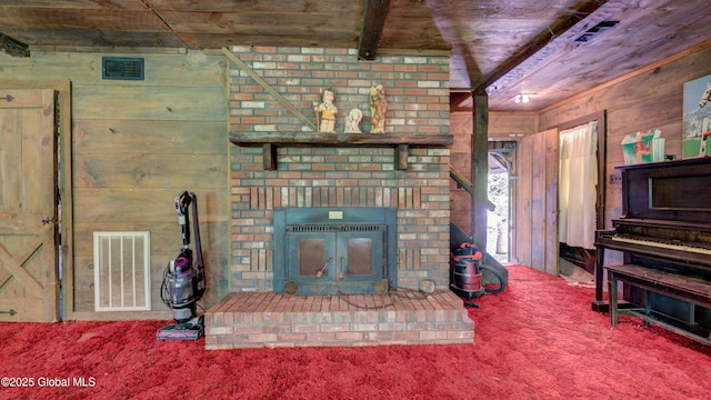 824 County Highway 106, Mayfield, NY 12010 - living area featuring carpet, wood walls, a brick fireplace, and wooden ceiling with exposed beams