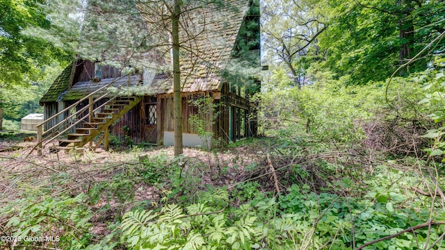 824 County Highway 106, Mayfield, NY 12010 - back of property with stairway and a forest view