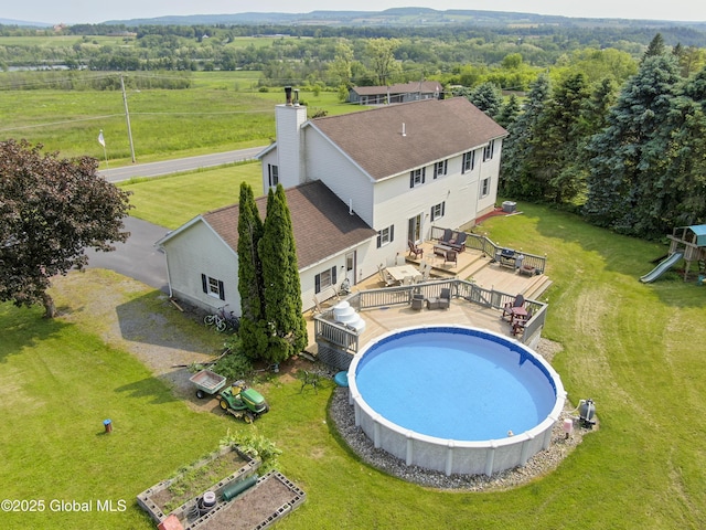 540 Mohawk Dr, Mohawk, NY 12068 - outdoor pool with a deck, a lawn, outdoor dining space, and a playground