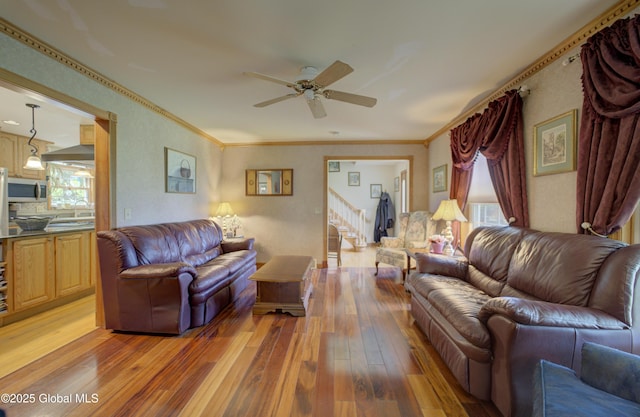 540 Mohawk Dr, Mohawk, NY 12068 - living area with light wood-style flooring, ceiling fan, healthy amount of natural light, stairs, and crown molding
