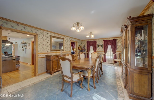 540 Mohawk Dr, Mohawk, NY 12068 - dining area with wallpapered walls, a wainscoted wall, a chandelier, ornamental molding, and light tile patterned floors