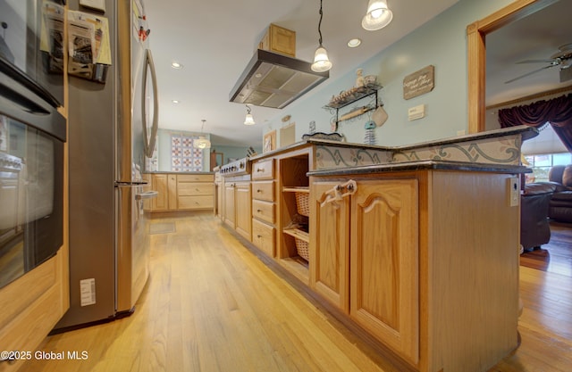 540 Mohawk Dr, Mohawk, NY 12068 - kitchen with extractor fan, light wood-style flooring, ceiling fan, freestanding refrigerator, and recessed lighting