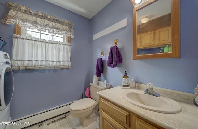540 Mohawk Dr, Mohawk, NY 12068 - bathroom featuring baseboard heating, vanity, toilet, and washer / dryer