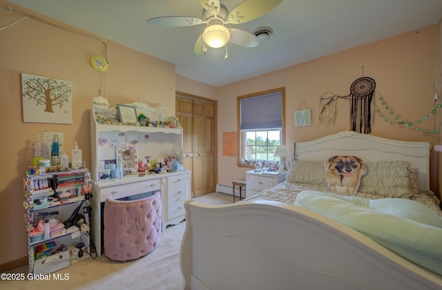 540 Mohawk Dr, Mohawk, NY 12068 - bedroom with light carpet, a baseboard heating unit, a closet, and a ceiling fan