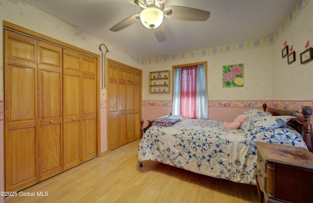 540 Mohawk Dr, Mohawk, NY 12068 - bedroom featuring wallpapered walls, light wood-style floors, two closets, wainscoting, and ceiling fan