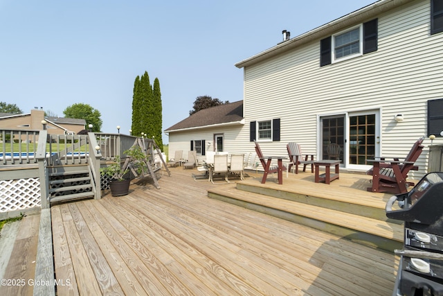 540 Mohawk Dr, Mohawk, NY 12068 - wooden terrace with outdoor dining area and a grill