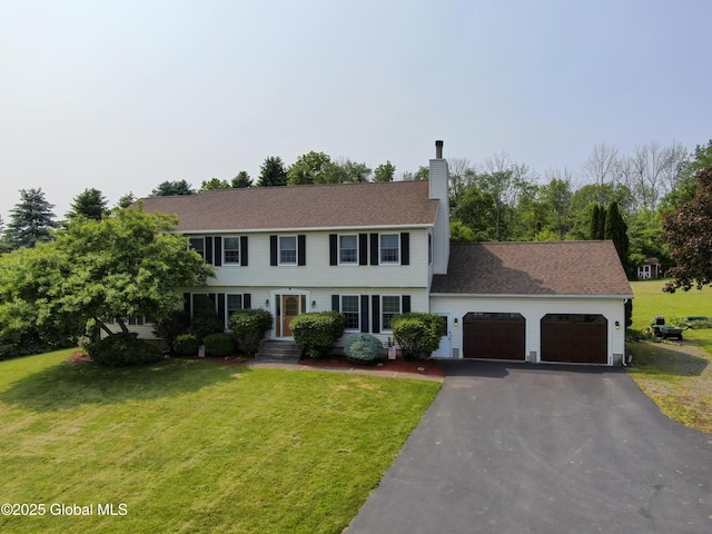 540 Mohawk Dr, Mohawk, NY 12068 - colonial home featuring a garage, a chimney, and a front yard
