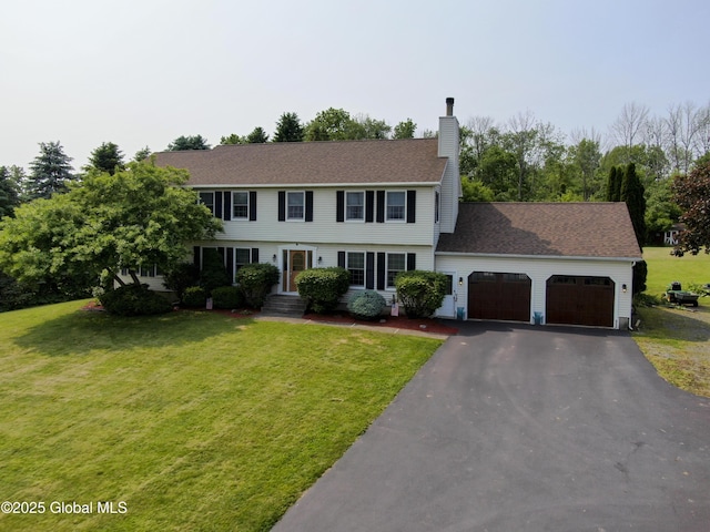 540 Mohawk Dr, Mohawk, NY 12068 - colonial inspired home featuring a garage, a chimney, driveway, and a front yard