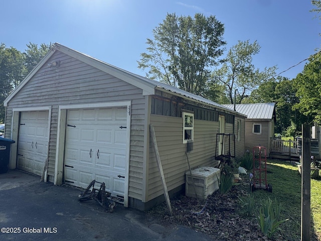351 Gansevoort Rd, Moreau, NY 12828 - view of side of home with a garage and metal roof