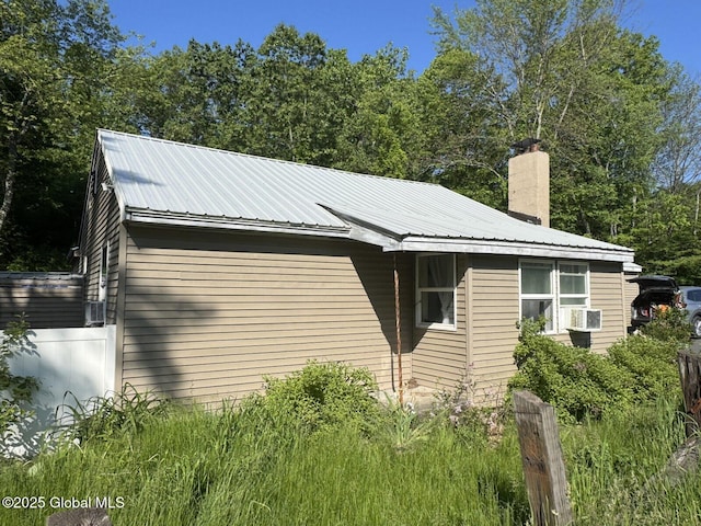 351 Gansevoort Rd, Moreau, NY 12828 - view of side of property with metal roof, a chimney, and cooling unit
