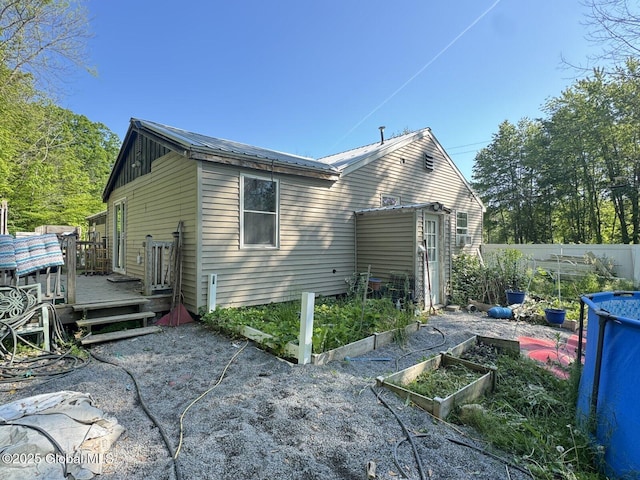 351 Gansevoort Rd, Moreau, NY 12828 - back of property with a deck, a garden, and metal roof