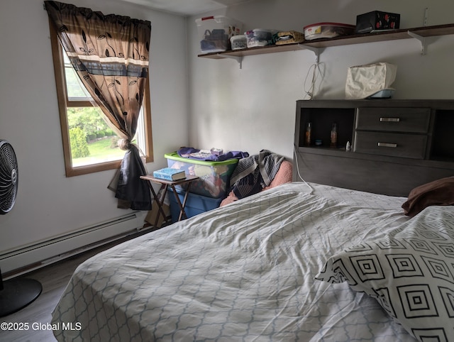 2714 Magnolia St, Endicott, NY 13760 - bedroom featuring wood finished floors and a baseboard heating unit