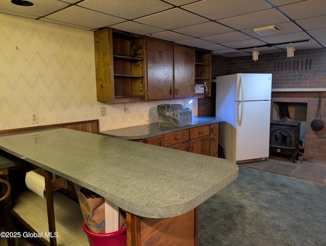 2714 Magnolia St, Endicott, NY 13760 - kitchen with open shelves, freestanding refrigerator, dark colored carpet, wallpapered walls, and a wood stove