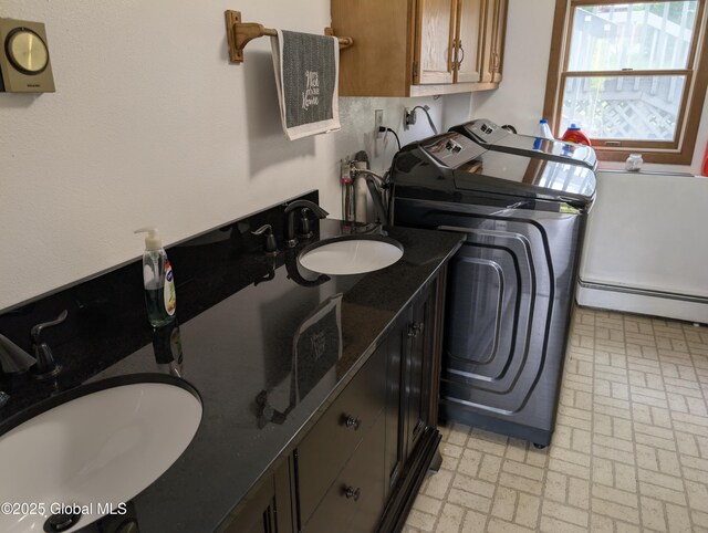 2714 Magnolia St, Endicott, NY 13760 - laundry room with washing machine and dryer, baseboard heating, brick patterned floors, and cabinet space