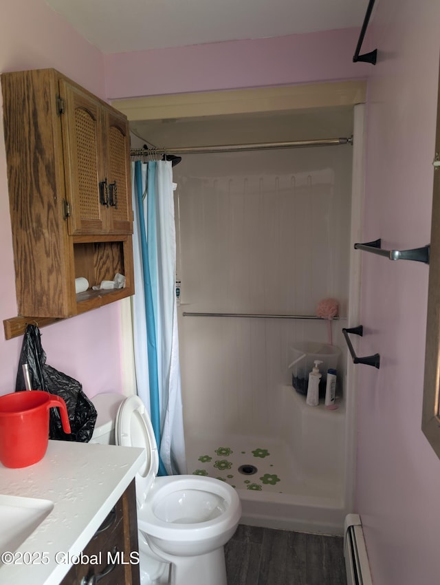 2714 Magnolia St, Endicott, NY 13760 - full bath featuring a shower stall, wood finished floors, vanity, toilet, and baseboard heating