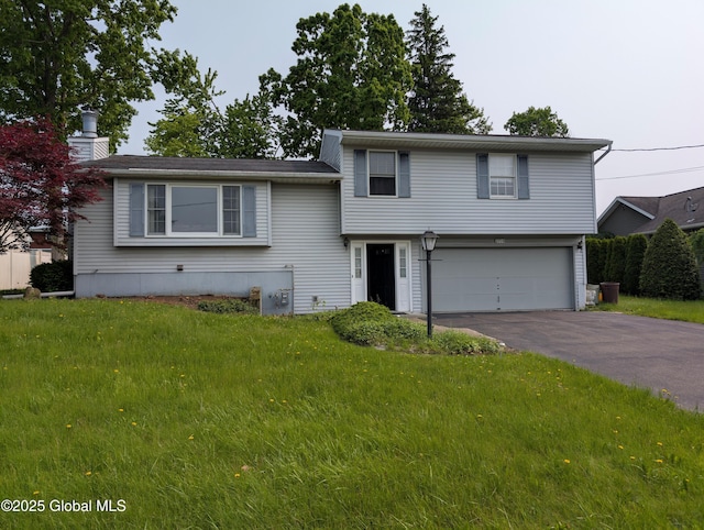 2714 Magnolia St, Endicott, NY 13760 - tri-level home featuring a garage, driveway, a front lawn, and a chimney