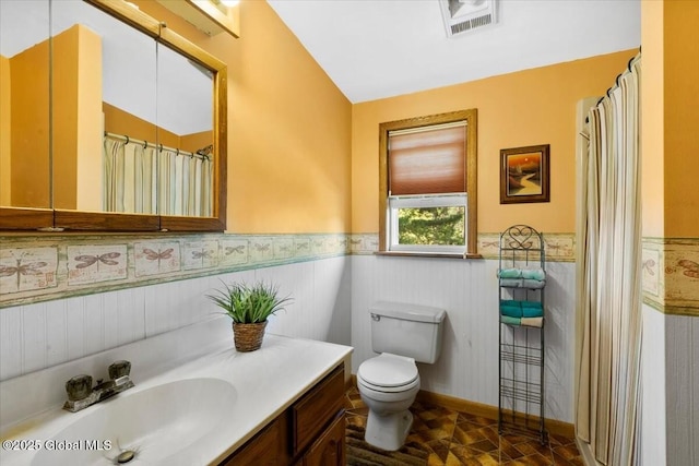92 Fiddlers Ln, Colonie, NY 12110 - full bath featuring toilet, vanity, and wainscoting