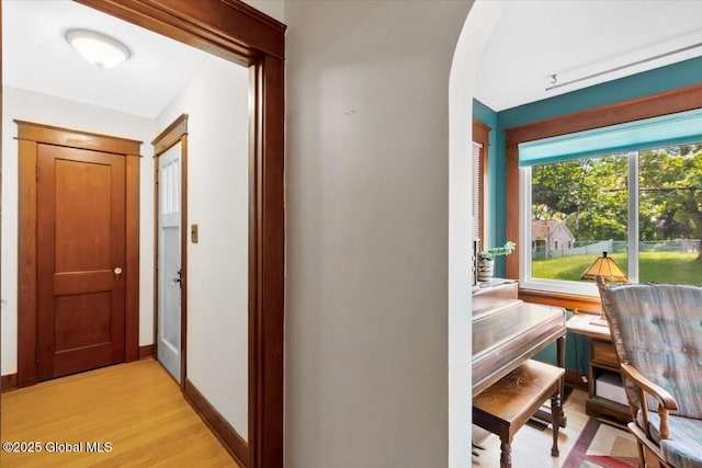 92 Fiddlers Ln, Colonie, NY 12110 - hallway featuring arched walkways, light wood finished floors, and baseboards