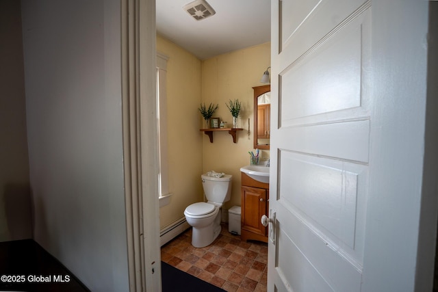 3 Grove St, Bethlehem, NY 12054 - half bath featuring toilet, vanity, and a baseboard heating unit