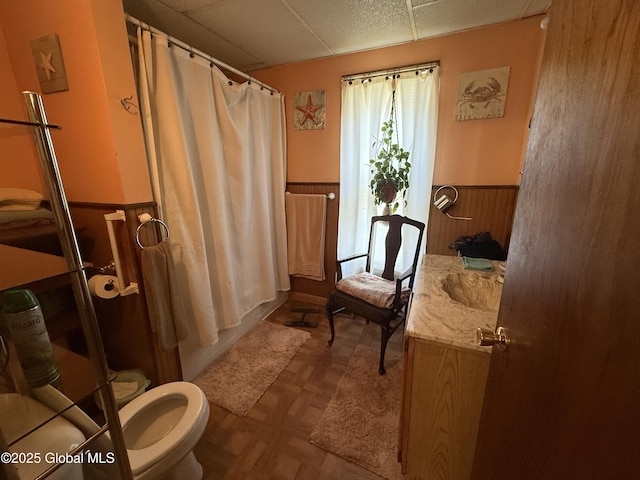 32 5th Ave, Gloversville, NY 12078 - bathroom with a wainscoted wall, toilet, vanity, a shower with curtain, and wooden walls