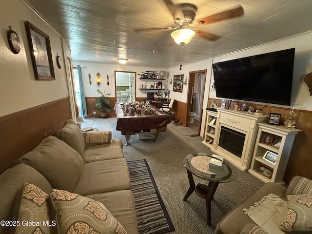 32 5th Ave, Gloversville, NY 12078 - living room with wainscoting, wood walls, ceiling fan, and carpet floors