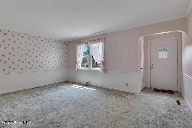 327 Sullivan Rd, Schenectady, NY 12304 - carpeted spare room with crown molding, arched walkways, and baseboards