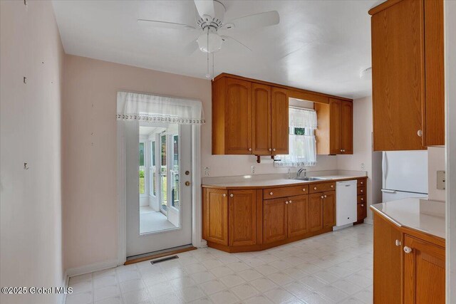 327 Sullivan Rd, Schenectady, NY 12304 - kitchen with white appliances, a sink, light countertops, and healthy amount of natural light