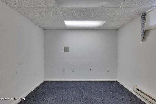 327 Sullivan Rd, Schenectady, NY 12304 - spare room featuring a baseboard radiator, dark colored carpet, a paneled ceiling, and baseboards