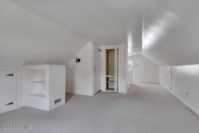 327 Sullivan Rd, Schenectady, NY 12304 - bonus room featuring built in shelves, vaulted ceiling, light carpet, and baseboards